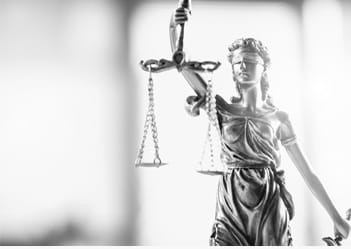 photo of a lady justice statue with scales representing the goal of justice